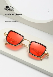 Detailed close-up of retro square metal sunglasses with orange lenses and golden frames