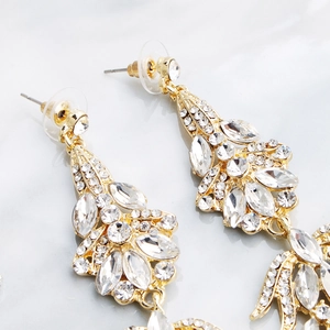 Close-up of luxury bridal drop earrings with sparkling marquise rhinestones in gold setting