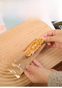 Translucent frosted food packaging bag showing nut tart on a wooden tray with white text