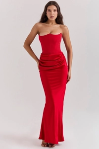Detailed draping and boning on a red satin off-shoulder evening gown bodice
