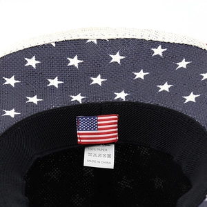 Close-up of paper cowboy hat interior showing 100% paper tag and US flag design