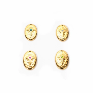 Detail of four gold oval pendants with colorful rhinestones and star relief patterns