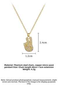 Detail view of gold titanium peace sign pendant necklace with micro-paved white stones