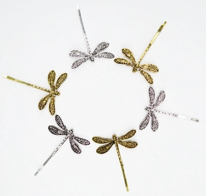 Detailed macro view of vintage dragonfly hairpins featuring intricate hollow wing textures