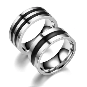 Macro view of minimalist titanium steel ring with black enamel striped pattern detail