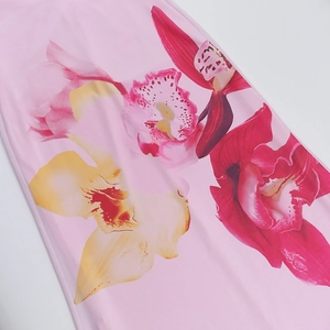 Detail of pink floral print fabric showing vibrant orchid patterns and smooth texture