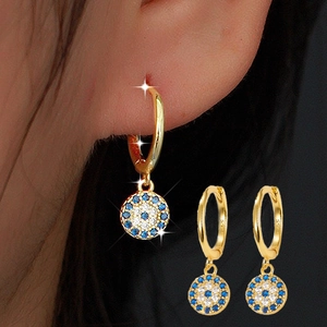 S925 sterling silver evil eye hoop earrings with blue and white crystals on model