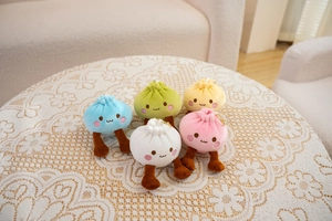 Close-up of five colorful plush bun keychains in white pink blue yellow and green