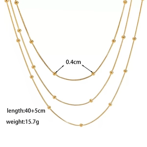 Detail view of layered gold bead necklace with 0.4cm beads and 40cm plus 5cm chain length