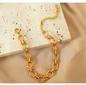 Detailed macro view of gold-plated titanium steel bracelet featuring S925 hallmarked charm