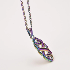 Detailed macro view of rainbow plated stainless steel witch knot pendant on a thin chain