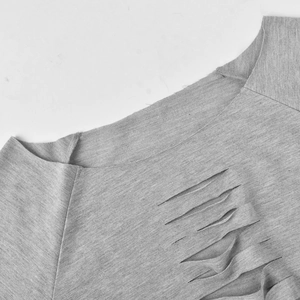 Detail of grey sweatshirt showing crew neck and parallel distressed cutout design