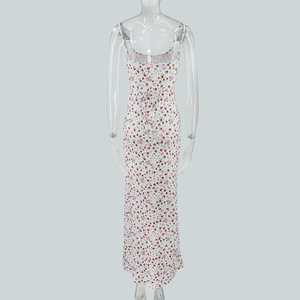 Detail of floral back tie-up design on long white summer dress with red flower patterns