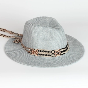 Detail of light blue straw fedora with ethnic geometric band and decorative long tassels