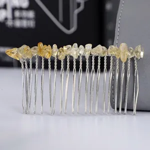 Macro detail of natural yellow crystal stones hand-wrapped on a silver metal hair comb