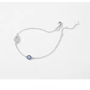 Detailed macro view of S925 sterling silver Hamsa hand and blue Evil Eye charm bracelet