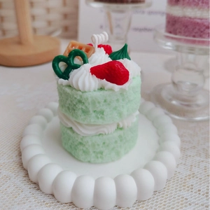 Green two-layer strawberry cake scented candle with chocolate and waffle decor