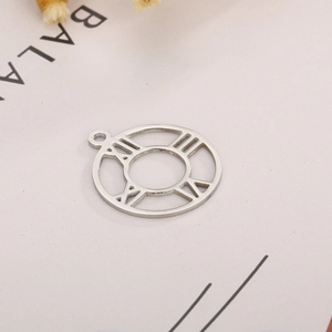 Macro detail of silver stainless steel pendant featuring hollow Roman numerals design