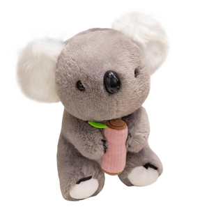 Cute plush koala stuffed animal with grey fur holding a pink branch and green leaf