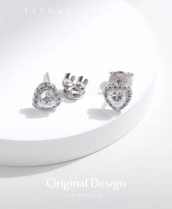 Macro detail of S925 sterling silver heart earrings with sparkling moissanite stones