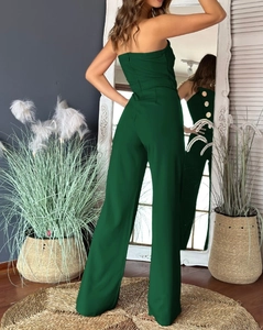 Detail of dark green strapless jumpsuit showing open back and decorative gold buttons