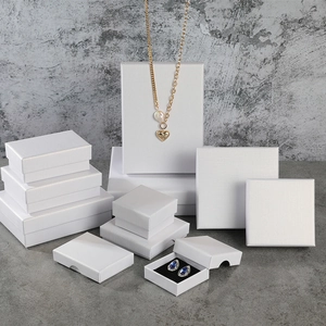Close-up of white linen textured jewelry gift boxes in various sizes for necklaces