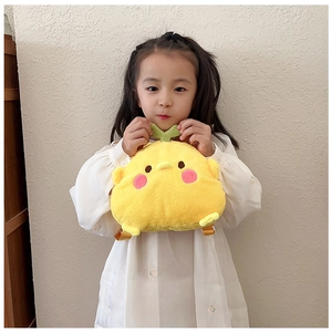 Detailed view of yellow plush duck backpack with green leaf on soft fabric