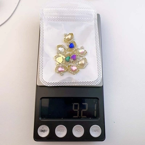 Colorful heart gemstone crown nail charms weighing 9.21g on a digital scale