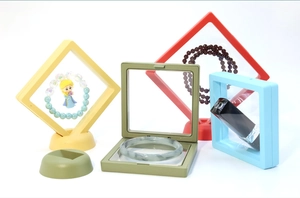 Detailed view of colorful PE film suspension jewelry boxes with matching stand bases