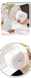 Close-up of soft blue toothbrush and white tooth plush toys with smiling faces