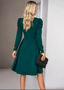 Back view of elegant dark green long sleeve dress with puff sleeves and A-line silhouette