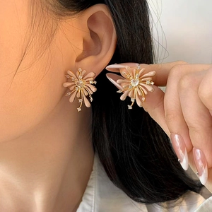Elegant gold flower stud earrings with beige enamel petals and sparkling zircon accents