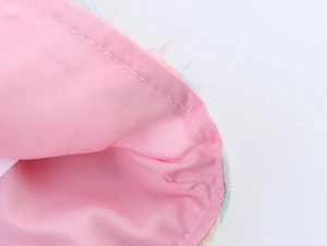 Close-up of pink embroidered shirt lining with precision stitching and fabric texture