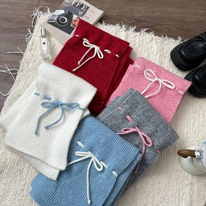 Knitted mini skirts set in red, white, blue, pink, and grey with drawstring waist details