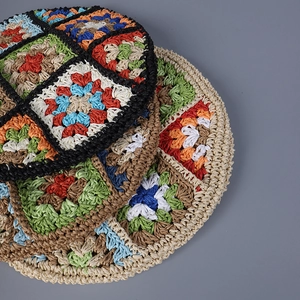 Detailed close-up of colorful handmade crochet granny square patterns on a summer beret hat