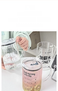 Detailed view of large high borosilicate glass mugs with straws and clear measurement marks