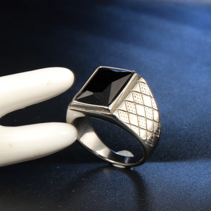 Detail of silver titanium ring with rectangle black stone on ceramic hand model
