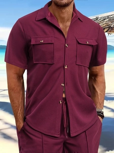 Detail of waffle knit fabric and chest pockets on a deep burgundy men's casual shirt