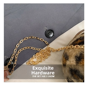 Detail shot of golden metal chain strap and leopard print faux fur texture of the bag
