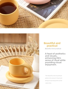 Detail of a bright yellow ceramic mug with a distinctive thick rounded handle on a saucer