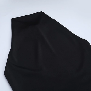 Macro shot of high-quality black plain weave fabric showing detailed texture and refined finish
