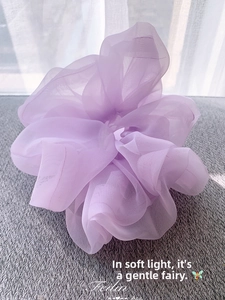 Detail of light purple organza scrunchie with soft cloud-like pleats and sheer texture