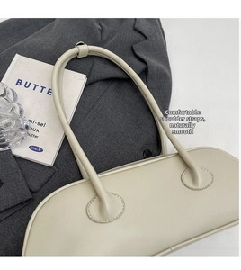Detail of soft cream white leather shoulder bag with smooth texture and comfortable straps