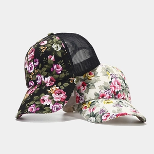 Floral mesh baseball cap in black and cream featuring rose patterns for outdoor wear
