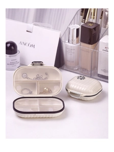 Mini suitcase-style portable pill box with internal compartments for jewelry or medicine
