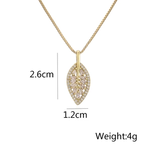 Detail of 18K gold leaf pendant with white zircons showing 2.6cm by 1.2cm size
