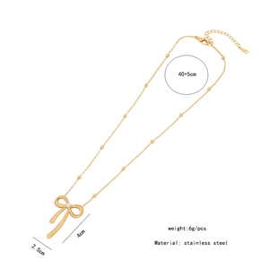 Detailed view of golden bow necklace dimensions and stainless steel material info