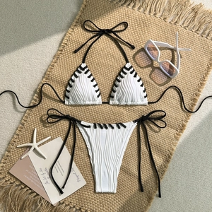 Detail of ribbed bikini set with contrast stitching and cross lace-up edges