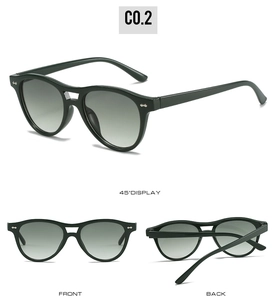 Detail view of dark green double-bridge sunglasses with silver rivet accents and gradient lenses