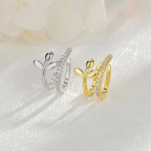 Detailed view of gold and silver leaf ear cuffs with shimmering pave zircon stones